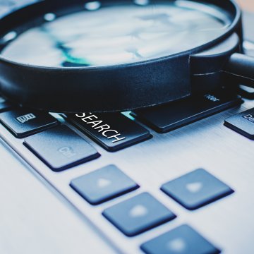 magnifying glass on keyboard background check services